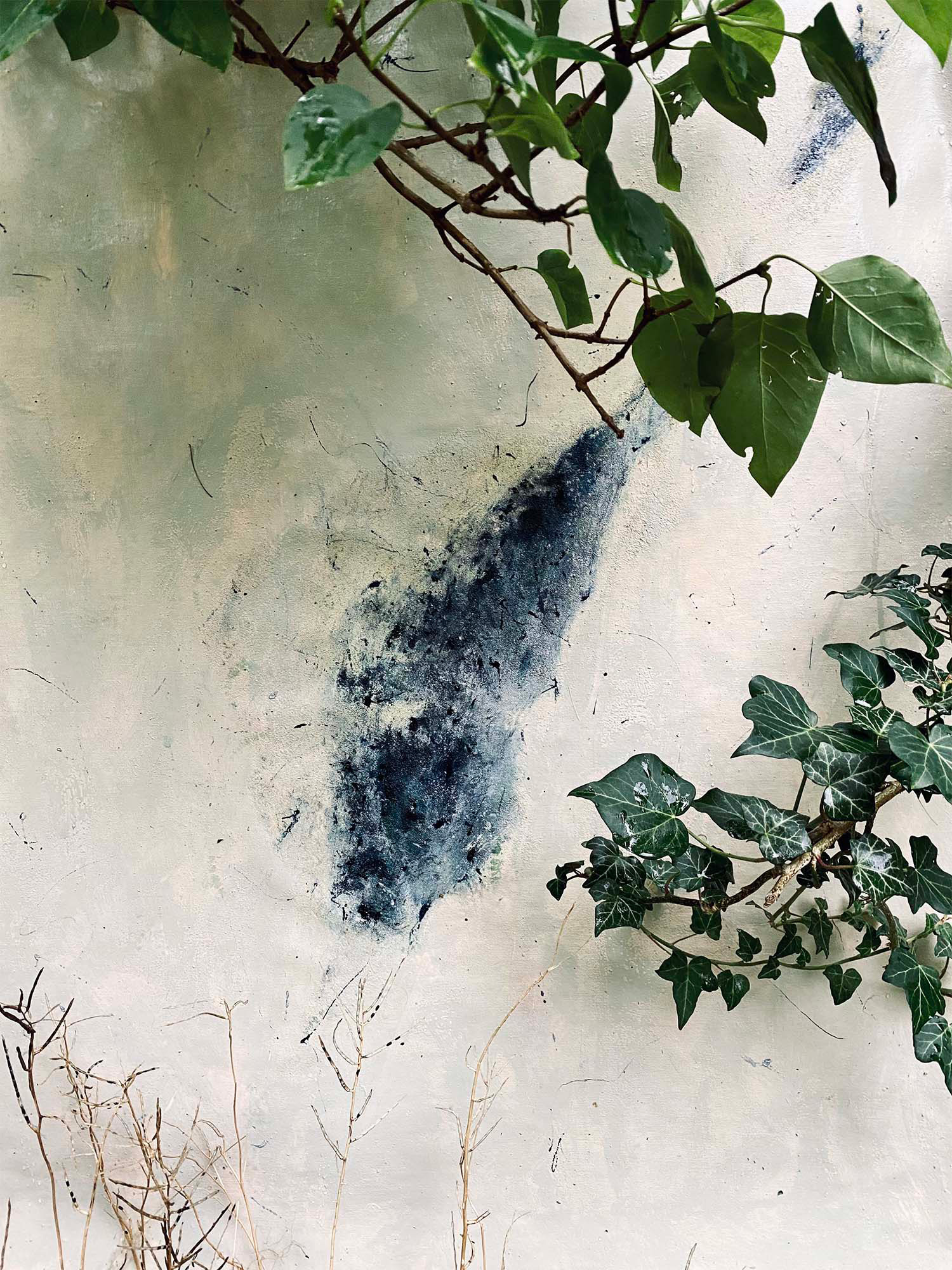 Abstract oil painting shown in installation view in garden